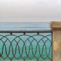 Rusted metal decorated protective fence of Stanley bridge at Alexandria with Mediterranean Sea in the background