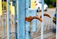 Rusted metal door handle on blue metal pole on sidewalk in Germany. Royalty Free Stock Photo