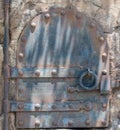 Rusted metal door with lock, with bolts Royalty Free Stock Photo