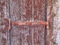 Rusted Metal Hinge on Flaking Wood Shutter