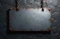 Rusted metal sign hangs on chains against textured wall. Blank rectangular plate with distressed edges awaits custom text or Royalty Free Stock Photo