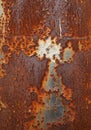 Rusted metal surface displaying a complex pattern of corrosion. The rust creates a Royalty Free Stock Photo