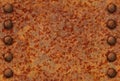 Rusted metal surface with rivets Royalty Free Stock Photo
