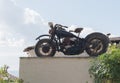 Rusted motorcycle on a roof in the back light Royalty Free Stock Photo