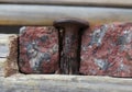 Rusted nail in broken granite