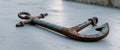 Rusted nautical anchor lying on the ground. Royalty Free Stock Photo