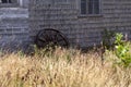Old wagon wheel against the barn Royalty Free Stock Photo