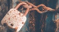 Rusted old iron lock and chain on wooden gate Royalty Free Stock Photo