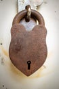 Rusted old lock on a door latch for safety. Vintage lock over a outdoor room