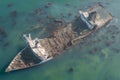 Rusted old tanker shipwreck stranded near the rugged coast