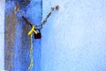 A rusted padlock against a blue wall Royalty Free Stock Photo