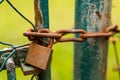 Rusted padlock and chain. Closed gate to the garden. Metal constructions. Royalty Free Stock Photo