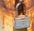 Rusted padlock on rusted pole