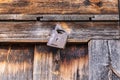 A rusted padlock on a wooden door