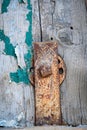 Rusted and painted old clasp with connector and boltt attached to wood boards with scraps of paint Royalty Free Stock Photo