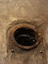 Rusted Pipe Opening in Dry Concrete or Soil Royalty Free Stock Photo