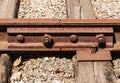 Rusted railway ties linked with bolts.