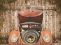 Rusted classic car in front of an old barn door Royalty Free Stock Photo