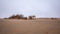 The rusted remains of an abandoned oil drilling rig between Henties Bay and Torra Bay, Skeleton Coast, Namibia. Royalty Free Stock Photo