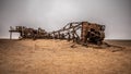 The rusted remains of an abandoned oil drilling rig between Henties Bay and Torra Bay, Skeleton Coast, Namibia. Royalty Free Stock Photo