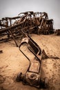 The rusted remains of an abandoned oil drilling rig between Henties Bay and Torra Bay, Skeleton Coast, Namibia. Royalty Free Stock Photo