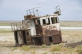 Rusted remains of fishing boats at the sea bed of the Aral sea, Aralsk, Kazakhstan.