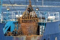 Rusted scallop dredge aboard scalloper Blue North leaving New Bedford, Massachusetts