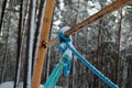 Rusted swing set metal with blue rope tied around metal structure Royalty Free Stock Photo