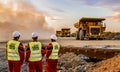 Large Dump Trucks transporting Platinum ore for processing with mining safety inspectors in the foreground