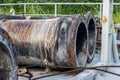 Rustic abandoned dredging pipes stored on a ship near the forest close up Royalty Free Stock Photo