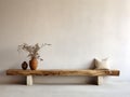 Rustic aged wood log bench near stucco empty wall with copy space. Boho interior design of modern living room