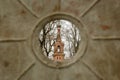 Glimpse of Divinity: Church Tower Through Metal Fence in Kuldiga, Latvija