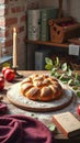 Rustic apple bread on wooden table with candle and foliage in cozy kitchen setting Royalty Free Stock Photo