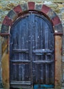 Rustic arched wooden door.