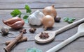 Culinary condiment and wooden spoon on a plank