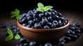 Rustic arrangement of ripe blueberries and fresh spearmint in clay bowl on wooden table