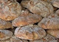 Rustic artisan bread loaves piled fresh from bakery oven Royalty Free Stock Photo