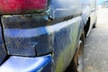 Close up shot of peeling and rusty car paint on the back of a car. Old and rusty car Royalty Free Stock Photo