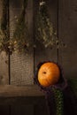 A rustic autumn still life with pumpkin, dry heral flowers and woolen scarf on a wooden surface. Thanksgiving, coutryside And Fall