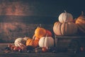 Rustic autumn still life with pumpkins and golden leaves on a wooden surface Royalty Free Stock Photo