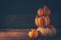 Rustic autumn still life with pumpkins and golden leaves on a wooden surface Royalty Free Stock Photo