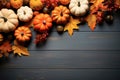 Rustic autumn top view background with autumn leaves and mini pumpkins with free space to copy text on a black rustic background