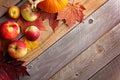 Rustic Autumn Wooden Background Framed by Apples and Fall Maple Royalty Free Stock Photo