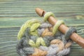 Rustic background, creative craft work. Closeup photo of crochet chain. Rustic crochet thread and a bamboo hook. Warm green winter