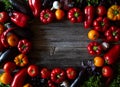 Rustic background with farm assortment vegetables, top view. Healthy food or vegetarian cooking concept.