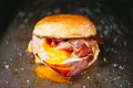 Rustic bacon egg breakfast sandwich bun Royalty Free Stock Photo