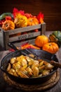 Rustic baked potatoes with herbs and pumpkins