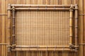 Rustic bamboo frame adorned with natural twine on a woven mat background. Generative AI Royalty Free Stock Photo