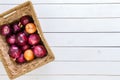 Rustic basket with a mix of red and brown onions