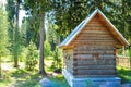 Rustic bath house with Windows made of laminated veneer lumber. Warm summer weather. Green lawn near the house. Decorative Christm Royalty Free Stock Photo